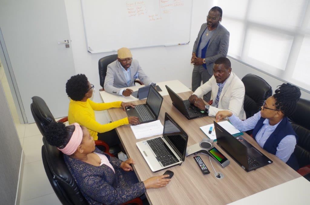An MTA consultant leading a planning session with colleagues at the office